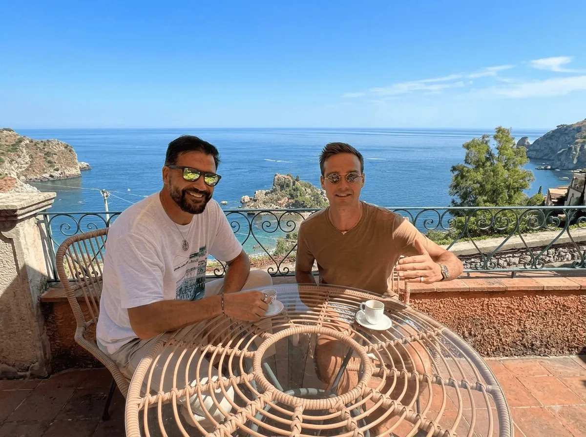 Nunzio and Nicolas in Taormina, with Isola Bella behind them